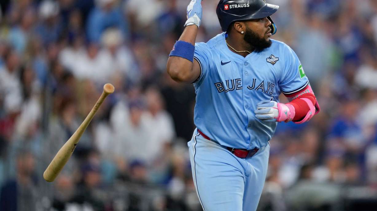 Toronto Blue Jays' Vladimir Guerrero Jr. flips his bat after hitting a two run against the Los Angeles Dodgers during the third inning in Game 4 of baseball's World Series, Tuesday, Oct. 28, 2025, in Los Angeles.