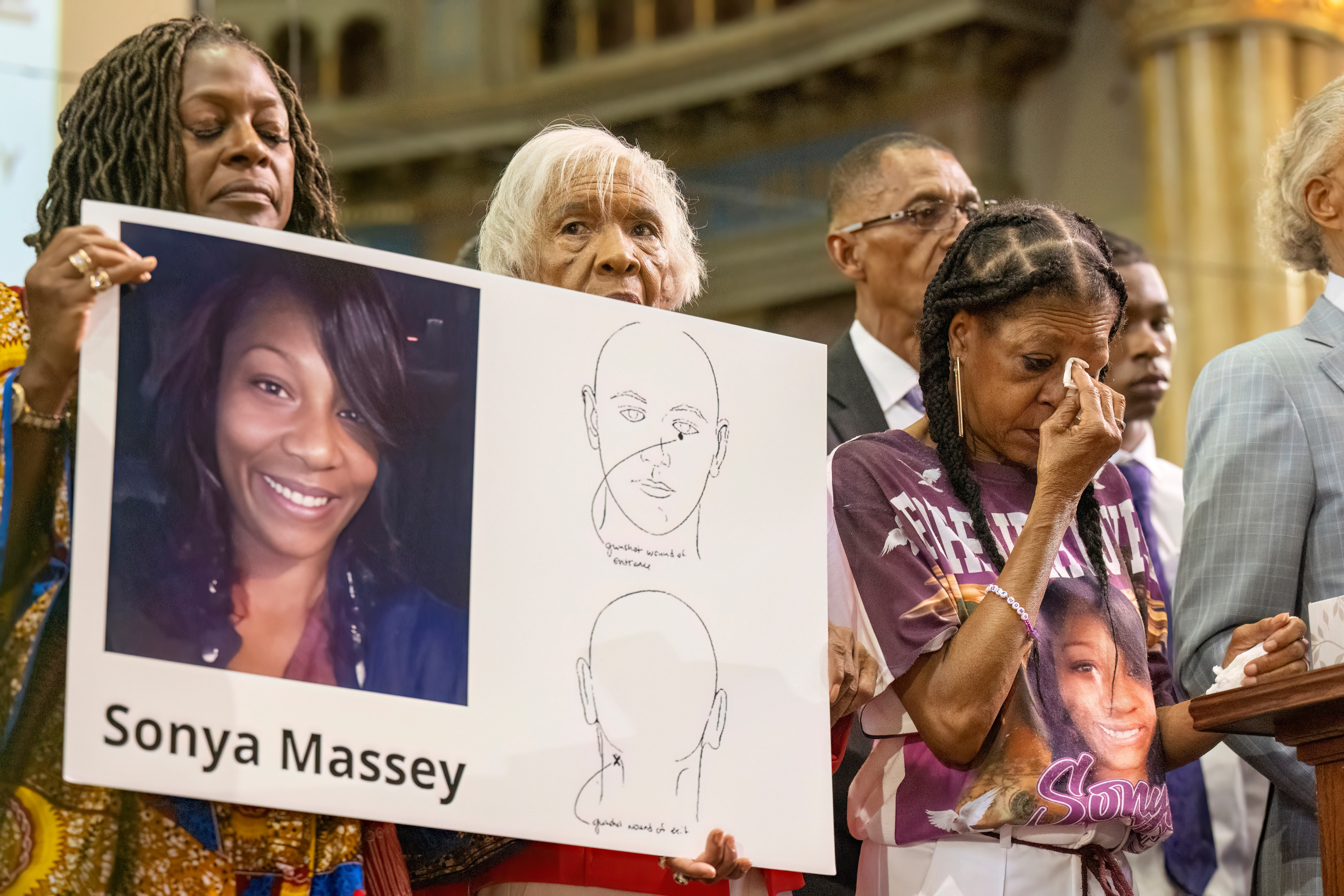 Donna Massey, center right, wipes tears from her face as she listens to Rev. Al Sharpton, right, speak during a press conference over the shooting death of her daughter, Sonya, who was killed by Illinois sheriff's deputy Sean Grayson, at New Mount Pilgrim Church in the Garfield Park neighborhood in Chicago, July 30, 2024. Wednesday, a jury found the deputy guilty of second-degree murder.