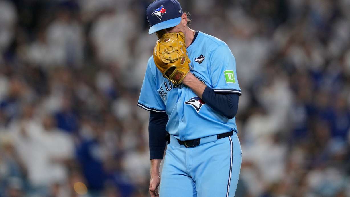 Toronto Blue Jays' pitcher Shane Bieber yells in his glove as he leaves the game during the sixth inning in Game 4 of baseball's World Series against the Los Angeles Dodgers, Tuesday, Oct. 28, 2025, in Los Angeles.