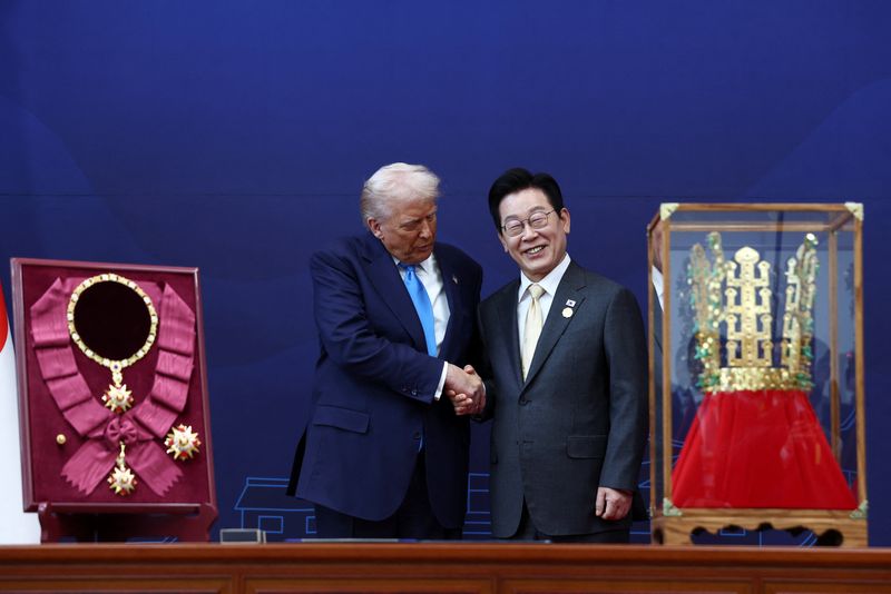 President Donald Trump is presented with the "Grand Order of Mugunghwa" and a replica gold crown during a meeting with South Korean President Lee Jae Myung on the sidelines of the Asia-Pacific Economic Cooperation leaders' summit in Gyeongju, South Korea, Wednesday.