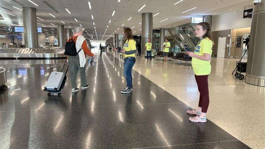 Several air traffic controllers gather at the baggage claim area of the Salt Lake City International Airport on their time off, handing out leaflets and urging travelers to pressure lawmakers to end the shutdown so they can get paid, Tuesday, in Salt Lake City.