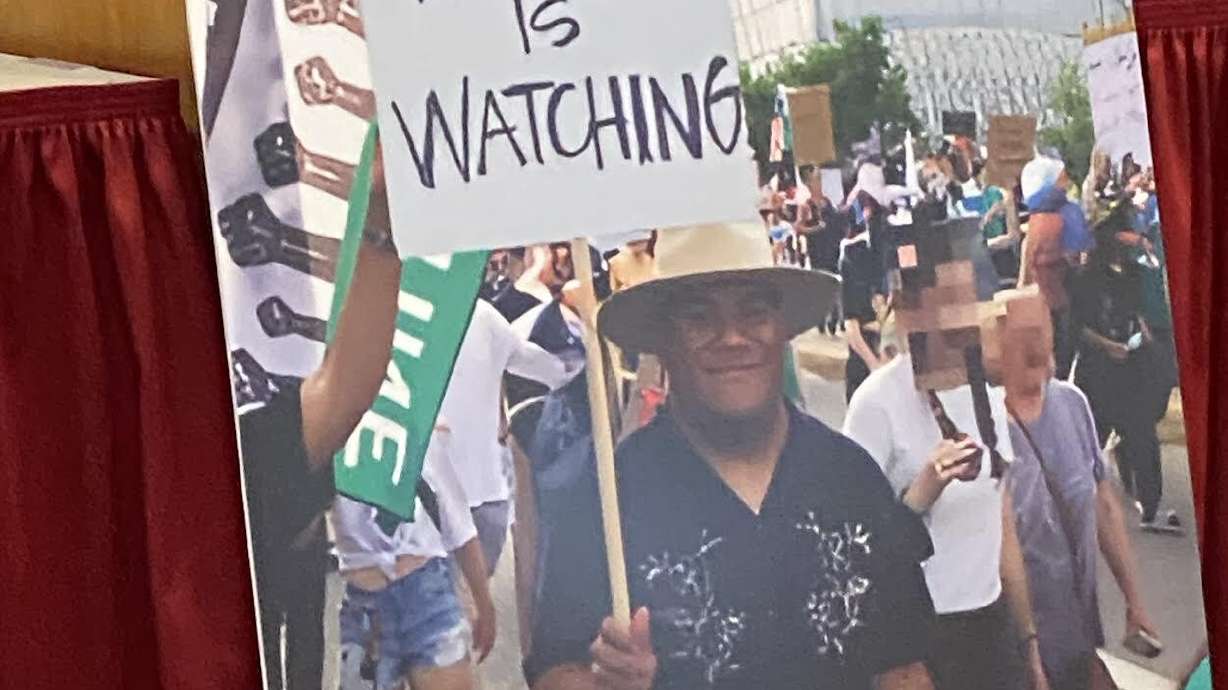 A photo of Arthur "Afa" Folasa Ah Loo protesting in Salt Lake City on June 14 is displayed during a press conference on Oct. 29, 2025, in Salt Lake City. Ah Loo was shot and killed during the protest. His widow filed a lawsuit Monday.