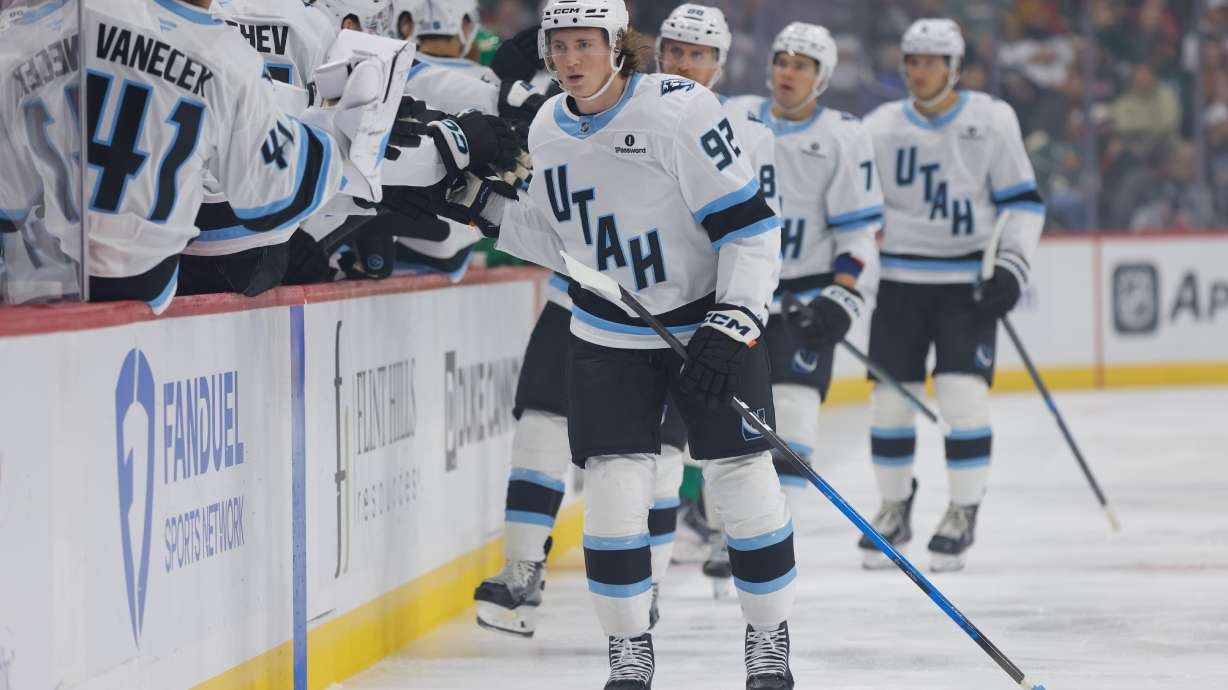 Utah Mammoth center Logan Cooley (92) is congratulated after scoring during the first period of an NHL hockey game against the Minnesota Wild, Saturday, Oct. 25, 2025, in St. Paul, Minn.