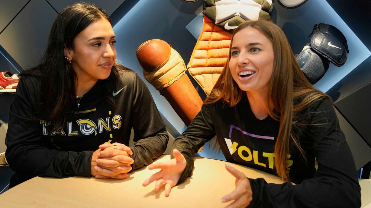FILE - Athletes Unlimited Softball League players Sharlize Palacios, left, of the Talons, and Sis Bates of the Bolts, are interviewed at Major League Baseball's headquarters in New York, Thursday, May 29, 2025. (AP Photo/Richard Drew, File