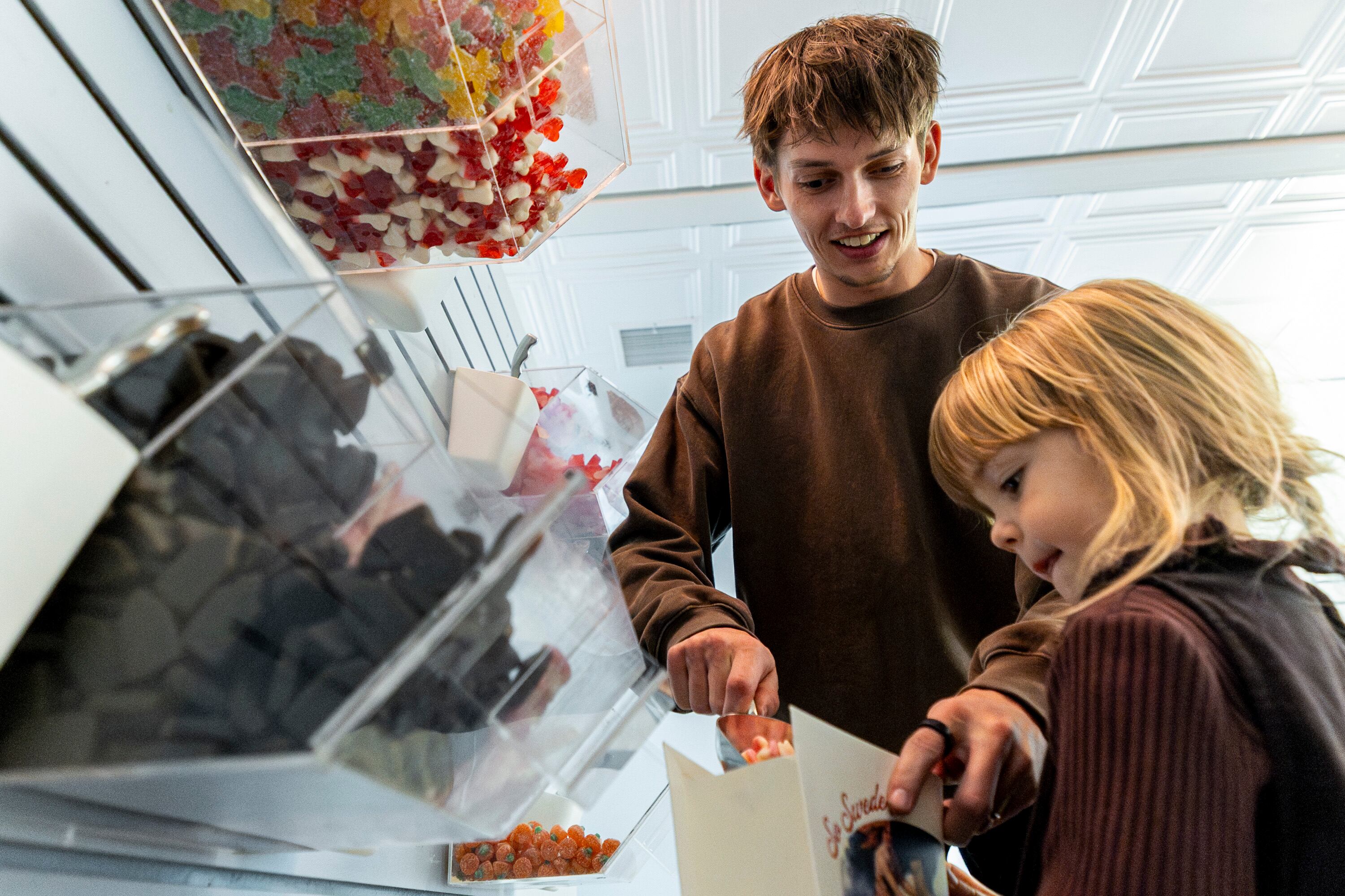 John Redd picks out candy for his daughter, Freya, at So Swede! in American Fork on Oct. 22. The hype around the Swedish candy store remains alive after its blockbuster opening a few months ago.