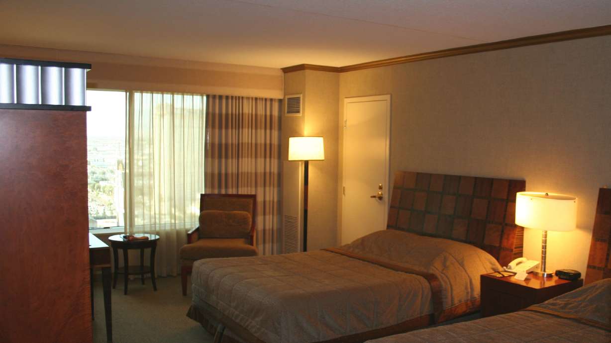 A man was arrested in southern Utah Tuesday night after allegedly shooting into an adjacent hotel room. He claimed he fired the gun while sleeping, police say.