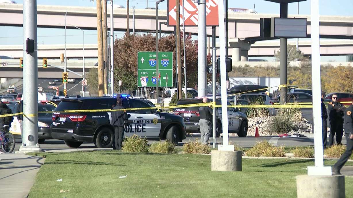 Police investigate after a man was shot and killed by a Salt Lake police officer at the corner of 2100 South and 300 West on Wednesday. The man was shot after allegedly throwing a rock at two police officers responding to a report of an assault, police said.