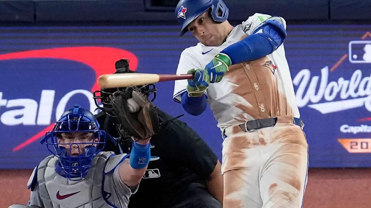 Toronto Blue Jays' George Springer strikes out during the eighth inning in Game 2 of baseball's World Series against the Los Angeles Dodgers, Saturday, Oct. 25, 2025, in Toronto.
