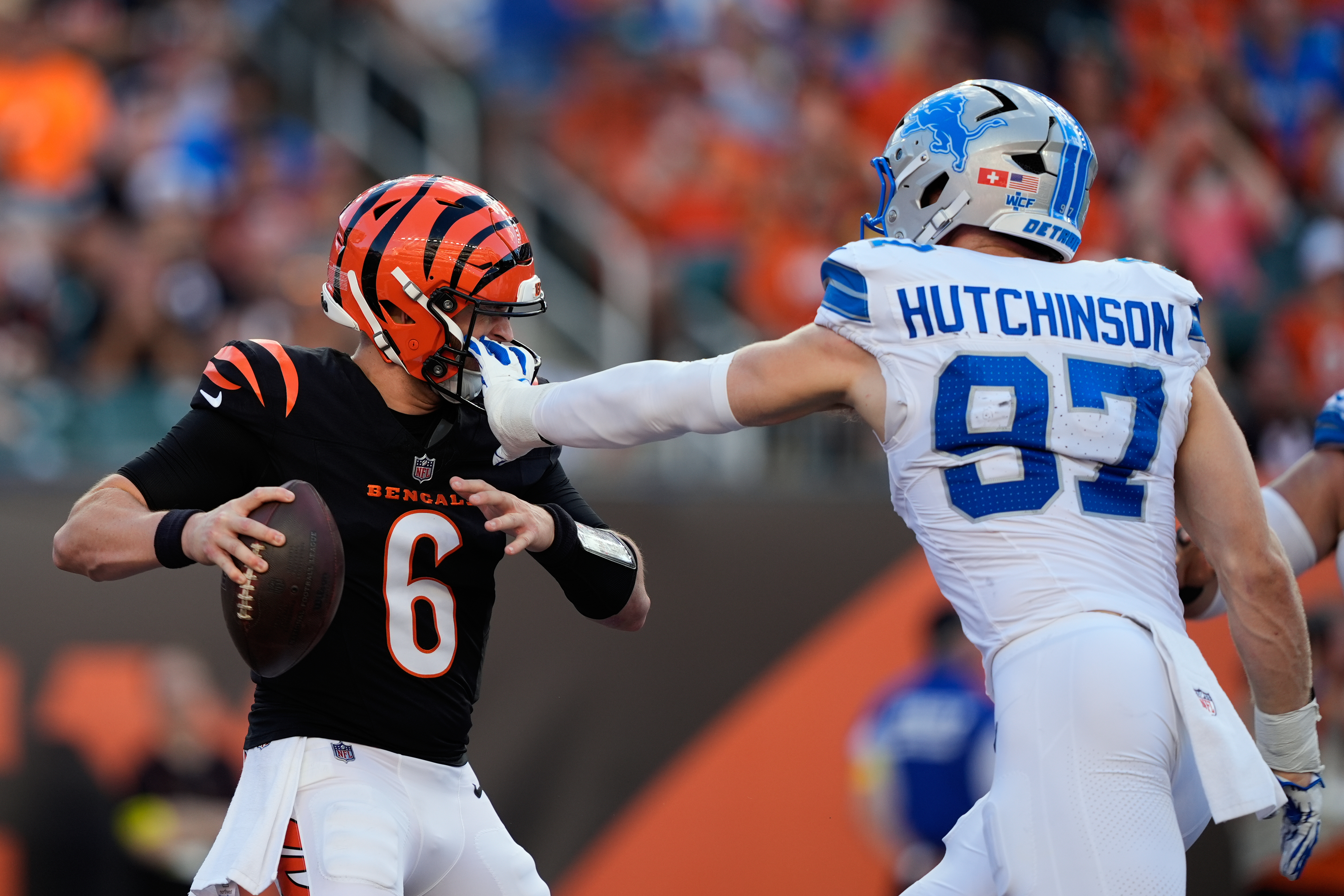 Detroit Lions defensive end Aidan Hutchinson (97) grabs Cincinnati Bengals quarterback Jake Browning (6) by the facemask during the first half of an NFL football game Sunday, Oct. 5, 2025, in Cincinnati.