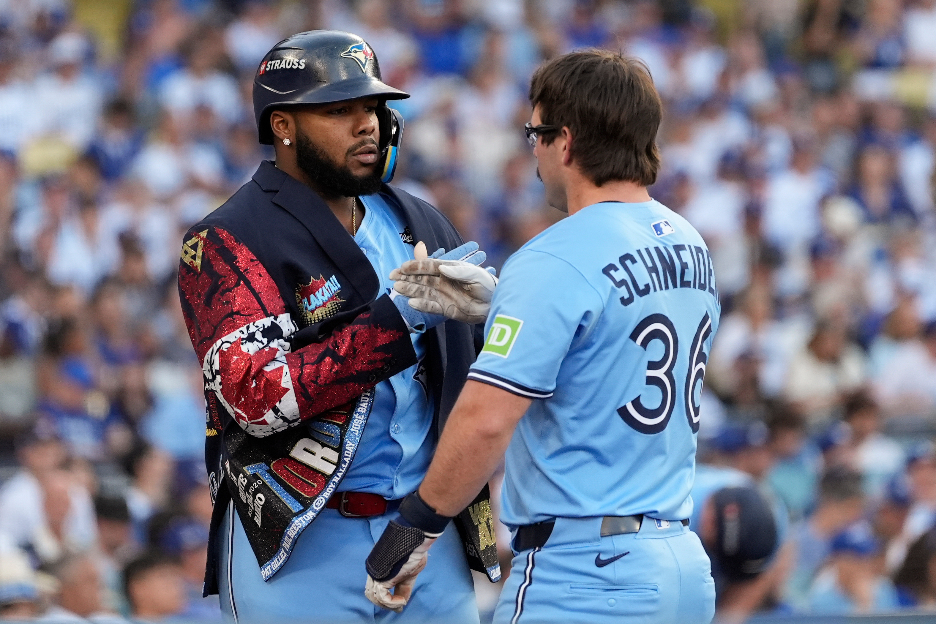 Toronto Blue Jays' Davis Schneider (36) celebrates with Vladimir Guerrero Jr. after their back-to-back home runs during the first inning in Game 5 of baseball's World Series against the Los Angeles Dodgers, Wednesday, Oct. 29, 2025, in Los Angeles. 