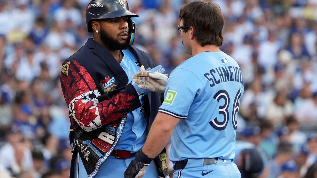 Toronto Blue Jays' Davis Schneider (36) celebrates with Vladimir Guerrero Jr. after their back-to-back home runs during the first inning in Game 5 of baseball's World Series against the Los Angeles Dodgers, Wednesday, Oct. 29, 2025, in Los Angeles.
