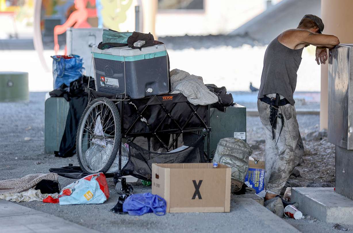 A man experiencing homelessness rests under an overpass in Salt Lake City on July 25. Utah's homelessness crisis has hit its highest levels this year.