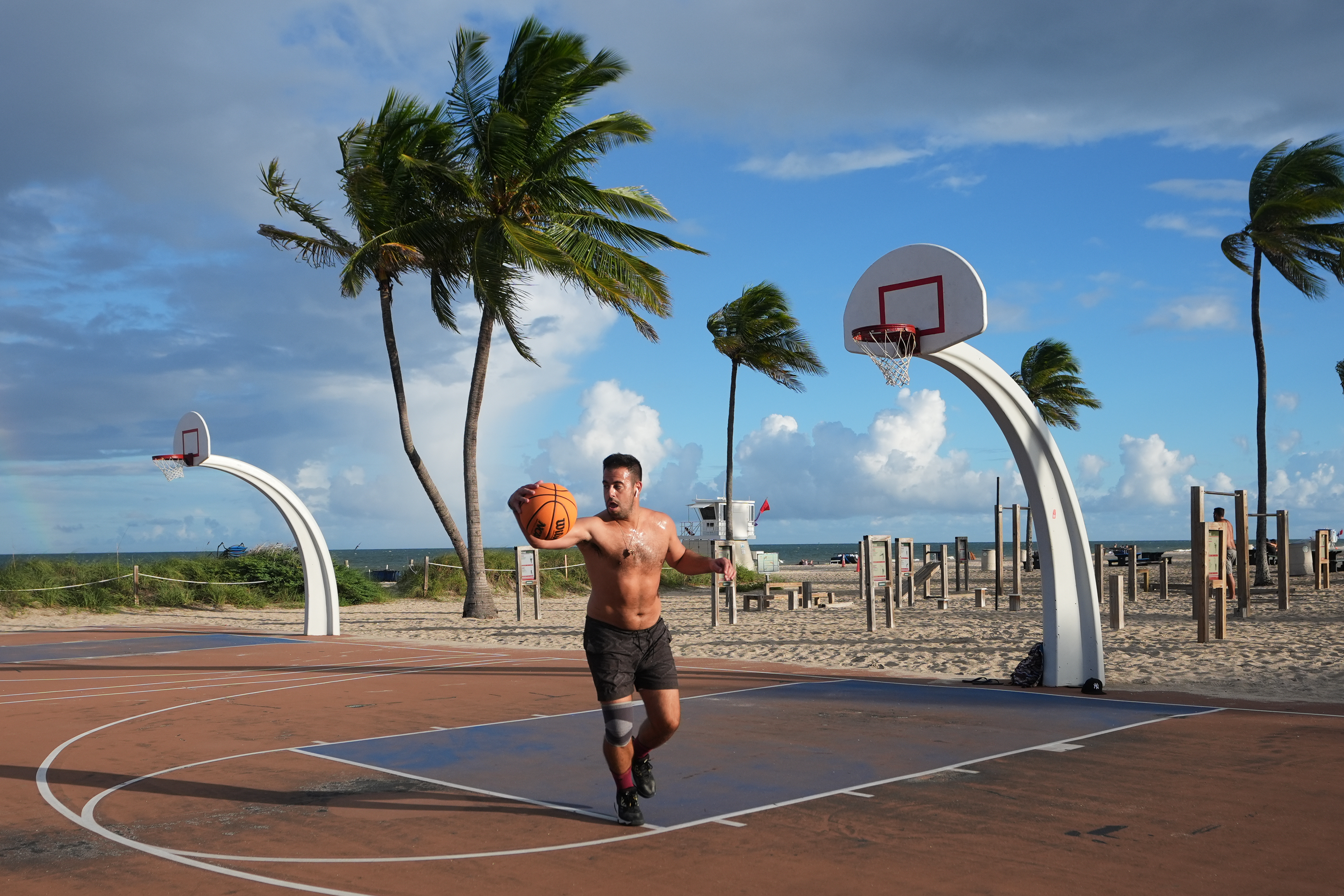 Gonzalo de Leon plays basketball at Fort Lauderdale Beach Park, the site of proposed pickleball courts as part of a new luxury development, Oct. 8, 2025, in Fort Lauderdale, Fla.