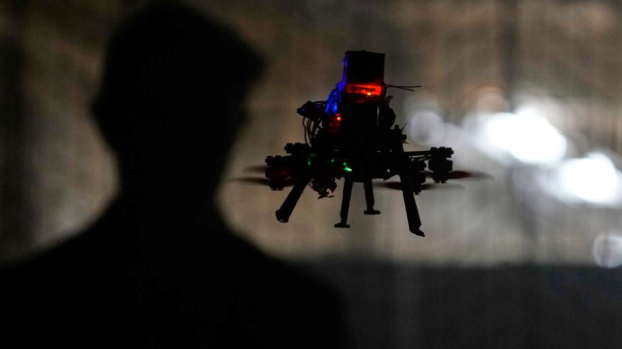 Colin Balfour flies a small drone at the Worcester Polytechnic Institute, Monday in Worcester, Mass. These tiny drones, inspired by bats, are being developed for search and rescue missions.