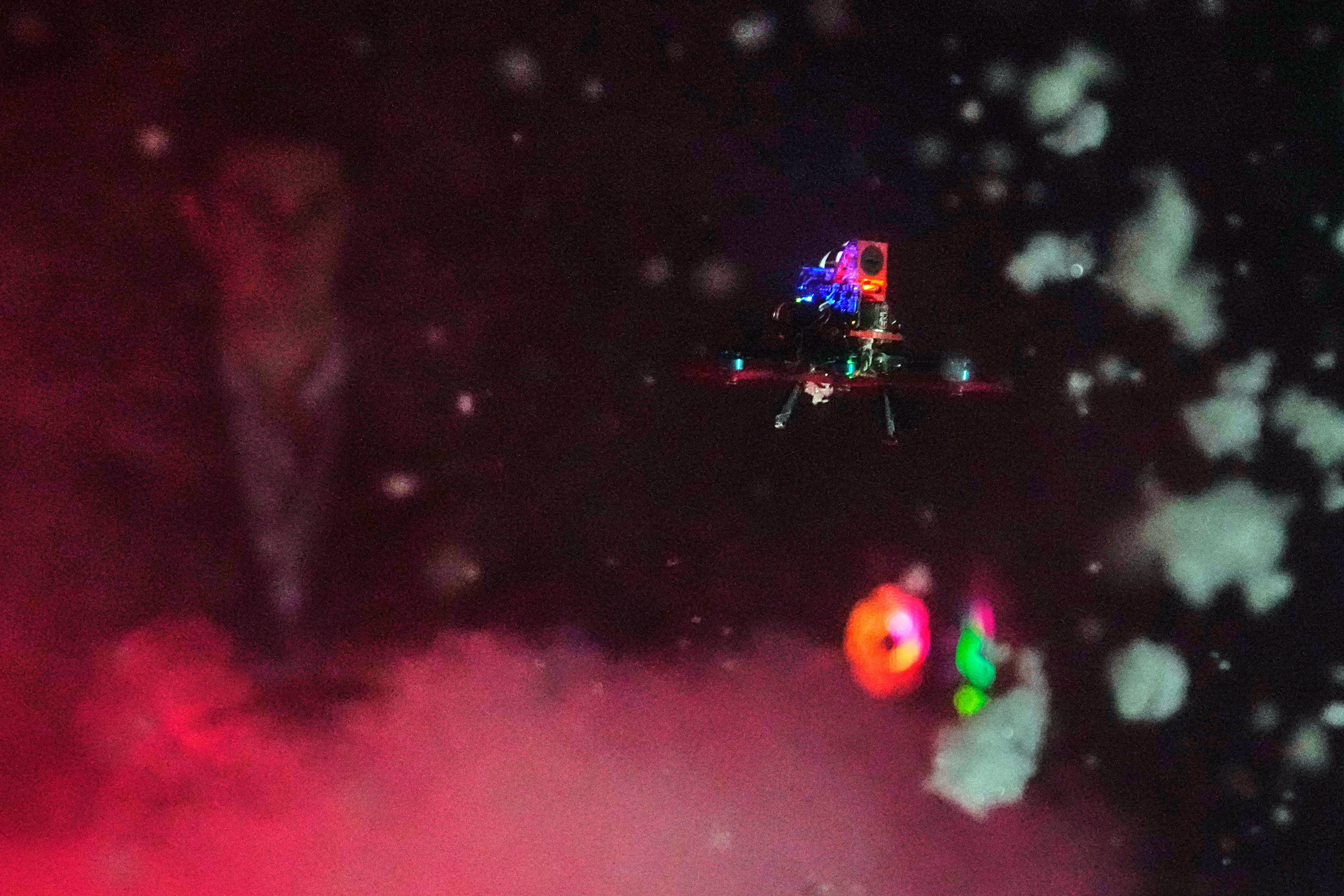 A tiny drone flies through a simulated snowstorm at Worcester Polytechnic Institute, Monday, in Worcester, Mass. The hope is that these types of drones will be used more often in search and rescue missions.