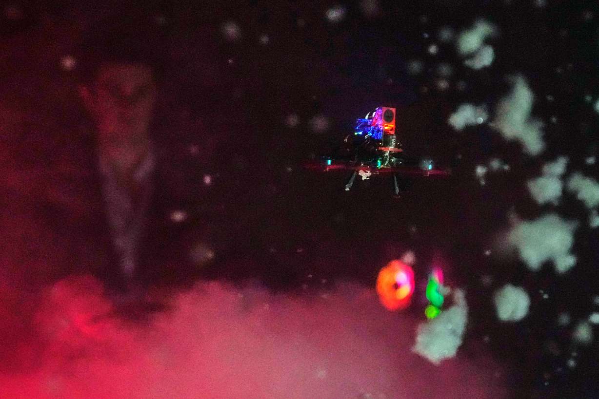 A tiny drone flies through a simulated snowstorm at Worcester Polytechnic Institute, Monday, in Worcester, Mass. The hope is that these types of drones will be used more often in search and rescue missions.