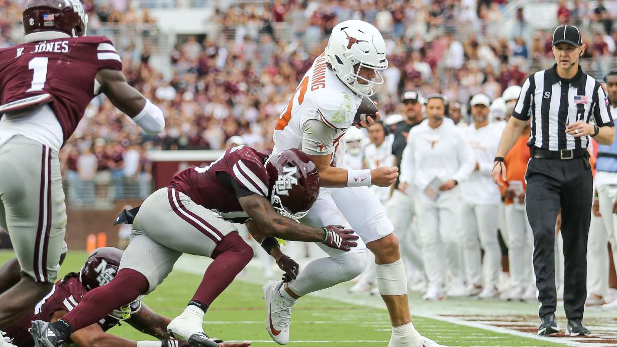 Texas quarterback Arch Manning, center right, runs out of bounds against Mississippi State safety Jahron Manning, center left, during the first half of an NCAA college football game in Starkville, Miss., Saturday, Oct. 25, 2025.