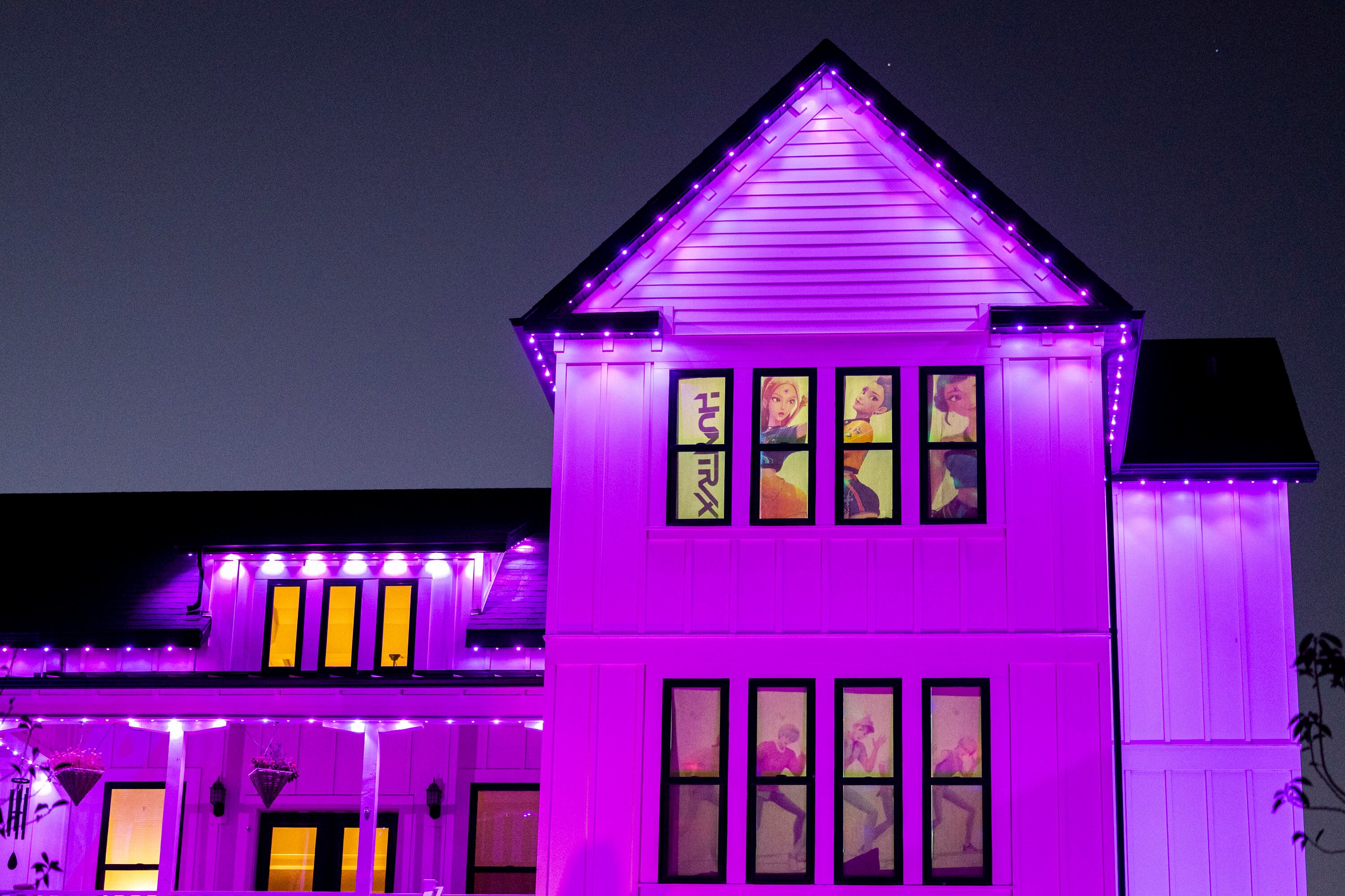 Video from ”KPop Demon Hunters” plays on the windows of Chelsey Vreeken's home in South Jordan on Tuesday. Vreeken said creating the decorations for the house was a team effort.