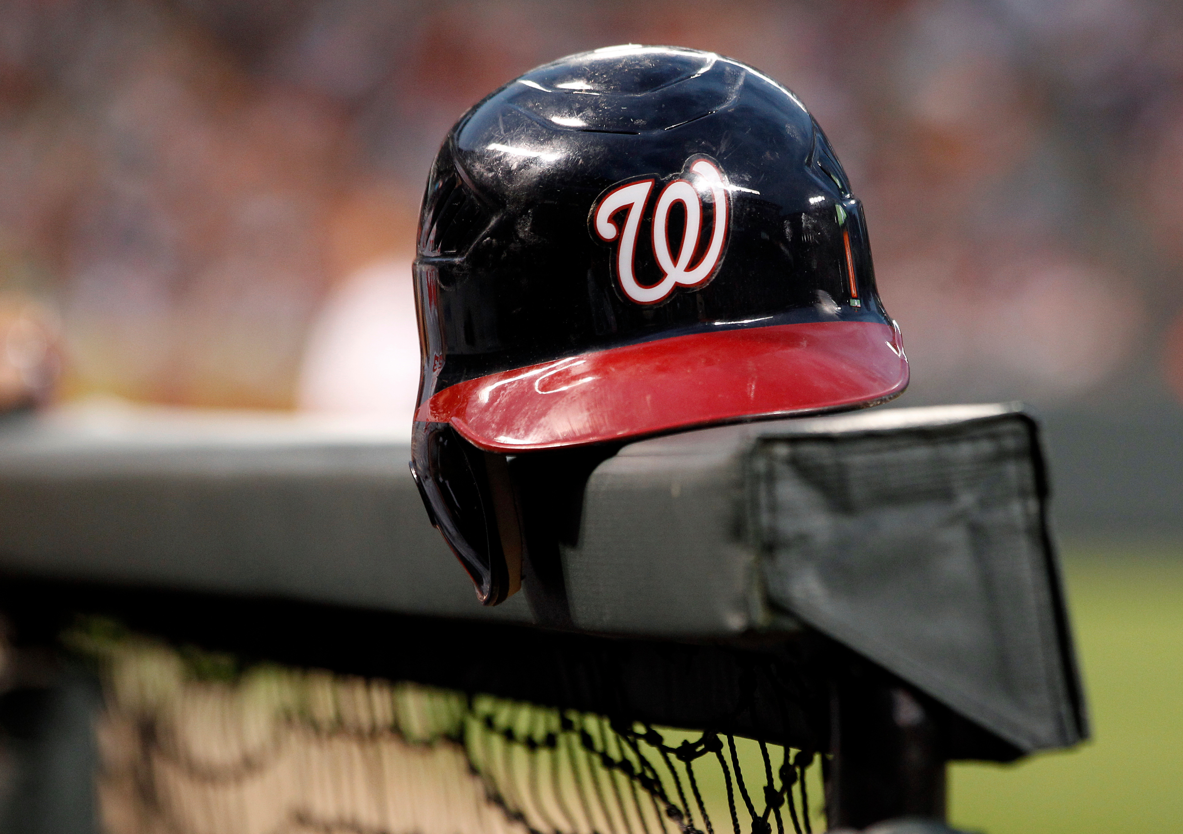 FILE - A Washington Nationals helmet sits in the dugout railing before a baseball game against the Baltimore Orioles in Baltimore, Friday, June 22, 2012. 