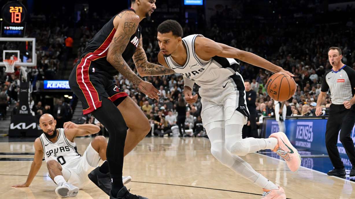 San Antonio Spurs center Victor Wembanyama, right, drives against Miami Heat center Kel'el Ware, front left, during the second half of an NBA basketball game, Thursday, Oct. 30, 2025, in San Antonio.