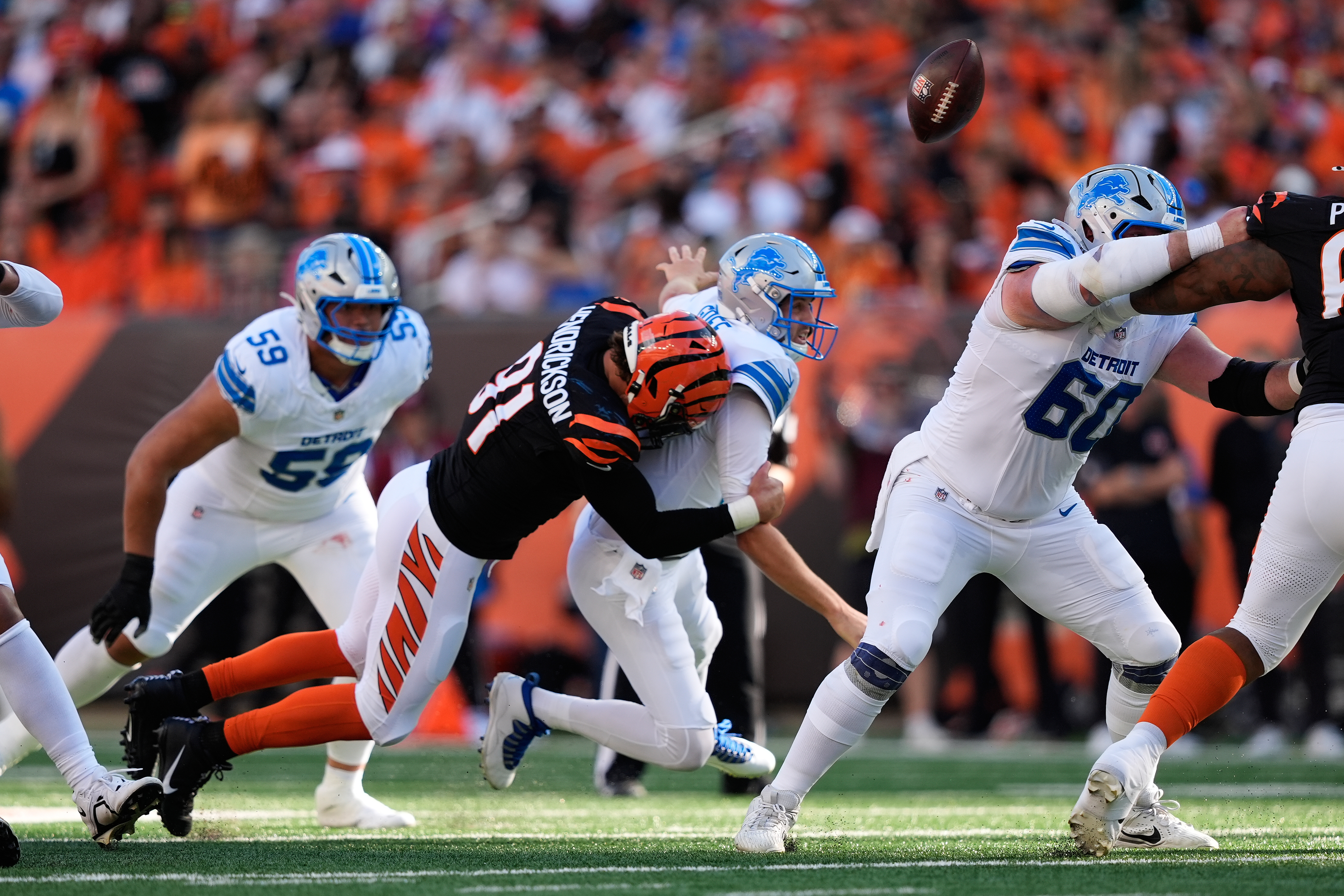 Cincinnati Bengals defensive end Trey Hendrickson (91) causes Detroit Lions quarterback Jared Goff (16) to fumble during the first half of an NFL football game Sunday, Oct. 5, 2025, in Cincinnati. 