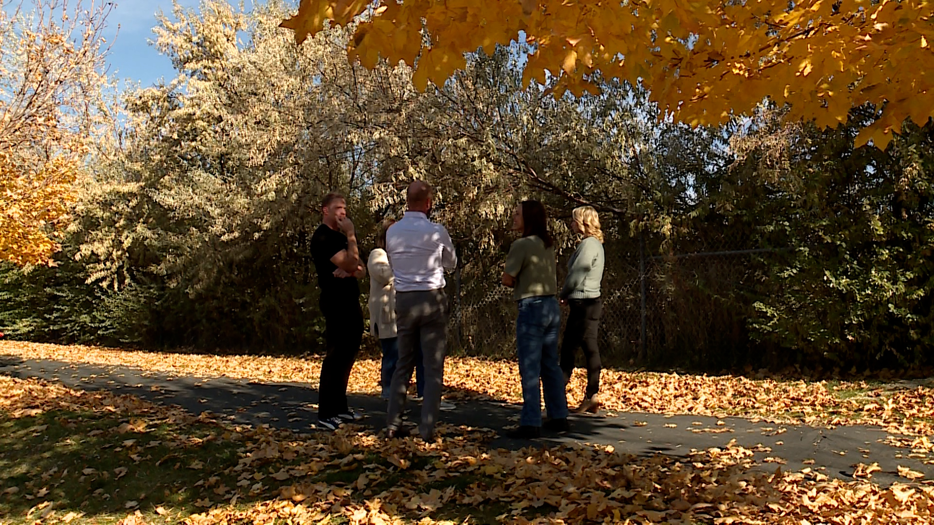 Residents of the Spring View Farms neighborhood in Bluffdale talk together on Thursday, near the site of a planned FrontRunner station.