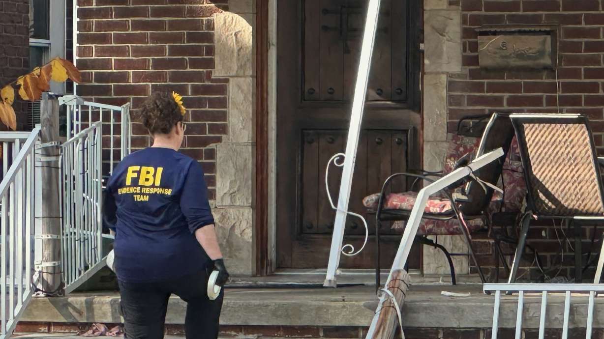 An FBI agent enters a home in a Dearborn, Mich., neighborhood on Friday. FBI Director Kash Patel said federal officials have arrested multiple people in Michigan who had allegedly been plotting a violent attack over the weekend.