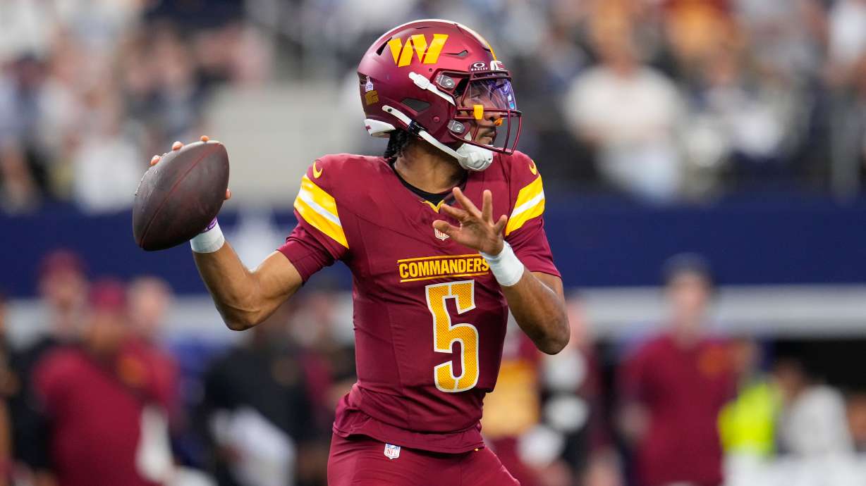 Washington Commanders quarterback Jayden Daniels (5) looks to pass against the Dallas Cowboys during the first half of an NFL football game Sunday, Oct. 19, 2025, in Arlington, Texas.