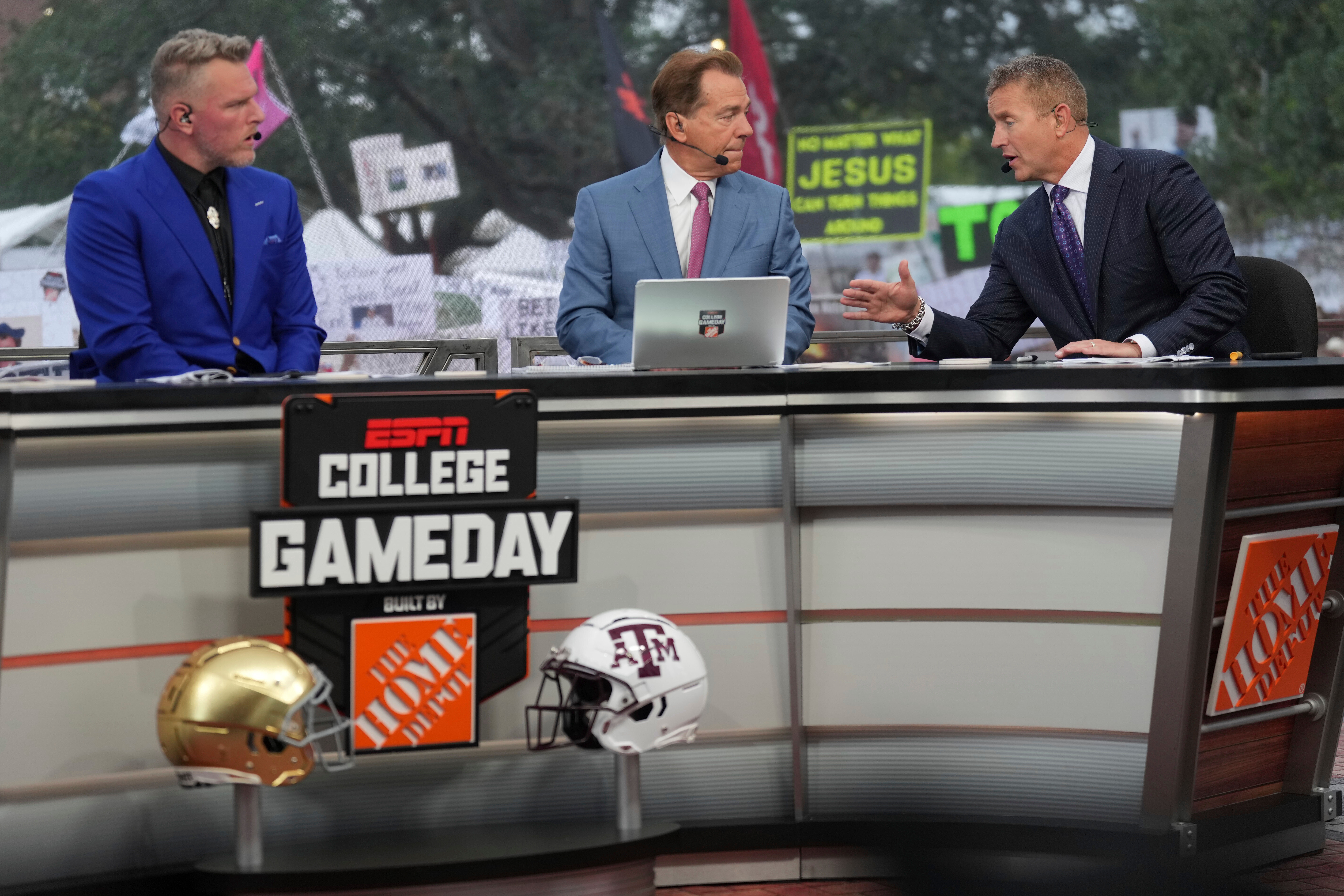 FILE - From left, Pat Mcafee, Nick Saban and Kirk Herbstreit talk on the set of ESPN College Gameday on Saturday, Aug. 31, 2024, in College Station, Texas. 