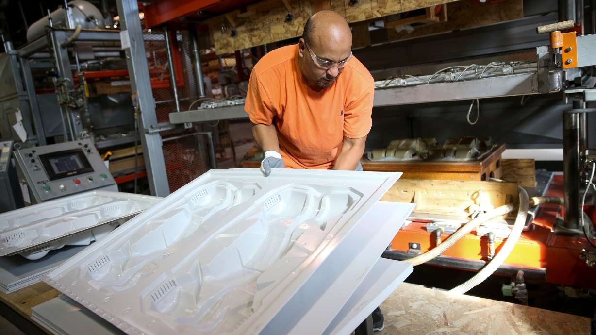 Tirso Pena removes plastic components from a mold at Kaddas Enterprises in Salt Lake City on Oct. 18, 2017. Goldman Sachs on Tuesday launched its $100 million "Investment in Rural Communities" program in Utah.