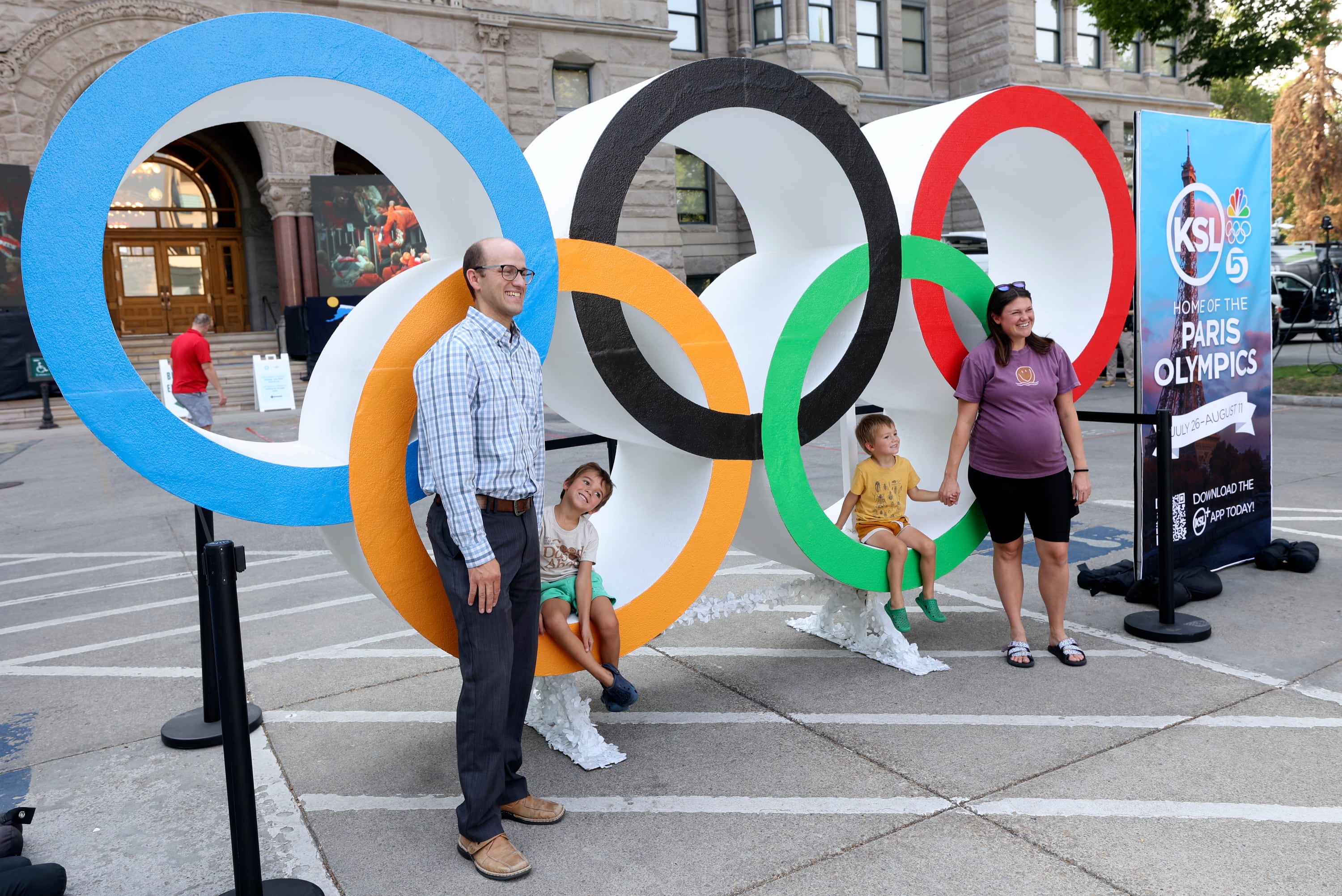 Trevor Jones, Indy Jones, Albion Jones and Lexi Jones pose for a family photo outside of the Salt Lake City-County Building in Washington Square in Salt Lake City on July 23, 2024 before a live watch party for the announcement that Utah will host the 2034 Olympic Winter Games.