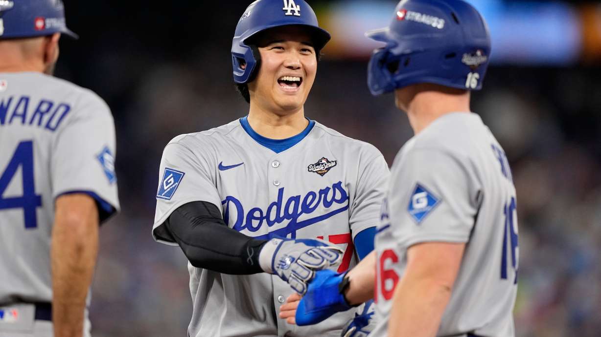 Los Angeles Dodgers' Shohei Ohtani and Will Smith talk during the eighth inning in Game 6 of baseball's World Series against the Toronto Blue Jays, Friday, Oct. 31, 2025, in Toronto.