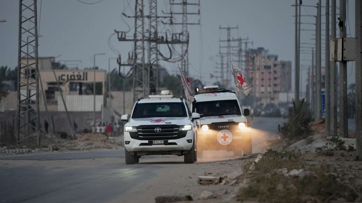 Red Cross vehicles make their way toward the Kissufim border crossing, in Deir al-Balah, central Gaza Strip, Thursday. Israel said Saturday the latest remains returned by Hamas are not hostages, another setback in the U.S.-brokered ceasefire.
