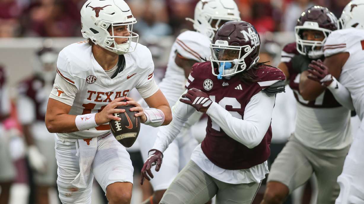 Texas quarterback Arch Manning, left, scrambles out of the pocket against Mississippi State linebacker Derion Gullette, front right, during the first half of an NCAA college football game in Starkville, Miss., Saturday, Oct. 25, 2025.