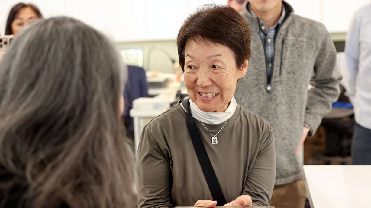 Karen Okawa holds a lid from the Japanese Church of Christ’s 101-year-old time capsule at the University of Utah in Salt Lake City on Oct. 20. The church held an unveiling ceremony Saturday to reveal the contents of the time capsule.