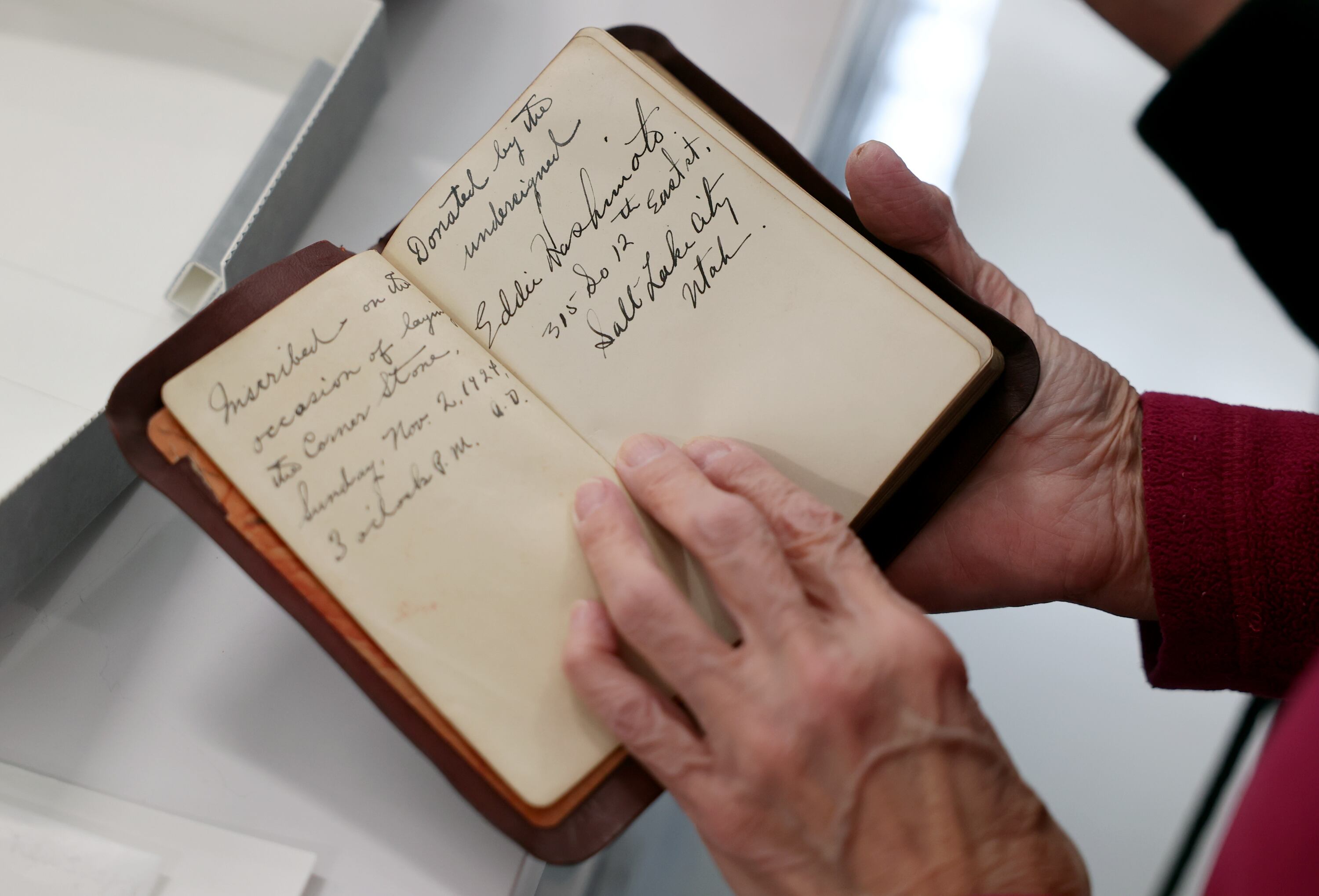 Joy Hashimoto Douglass holds a Bible donated in 1924 by her father, Eddie Hashimoto, and included in the contents of the Japanese Church of Christ’s 101-year-old time capsule that was recently opened at the University of Utah Marriott Library Preservation Department in Salt Lake City on Oct. 20.