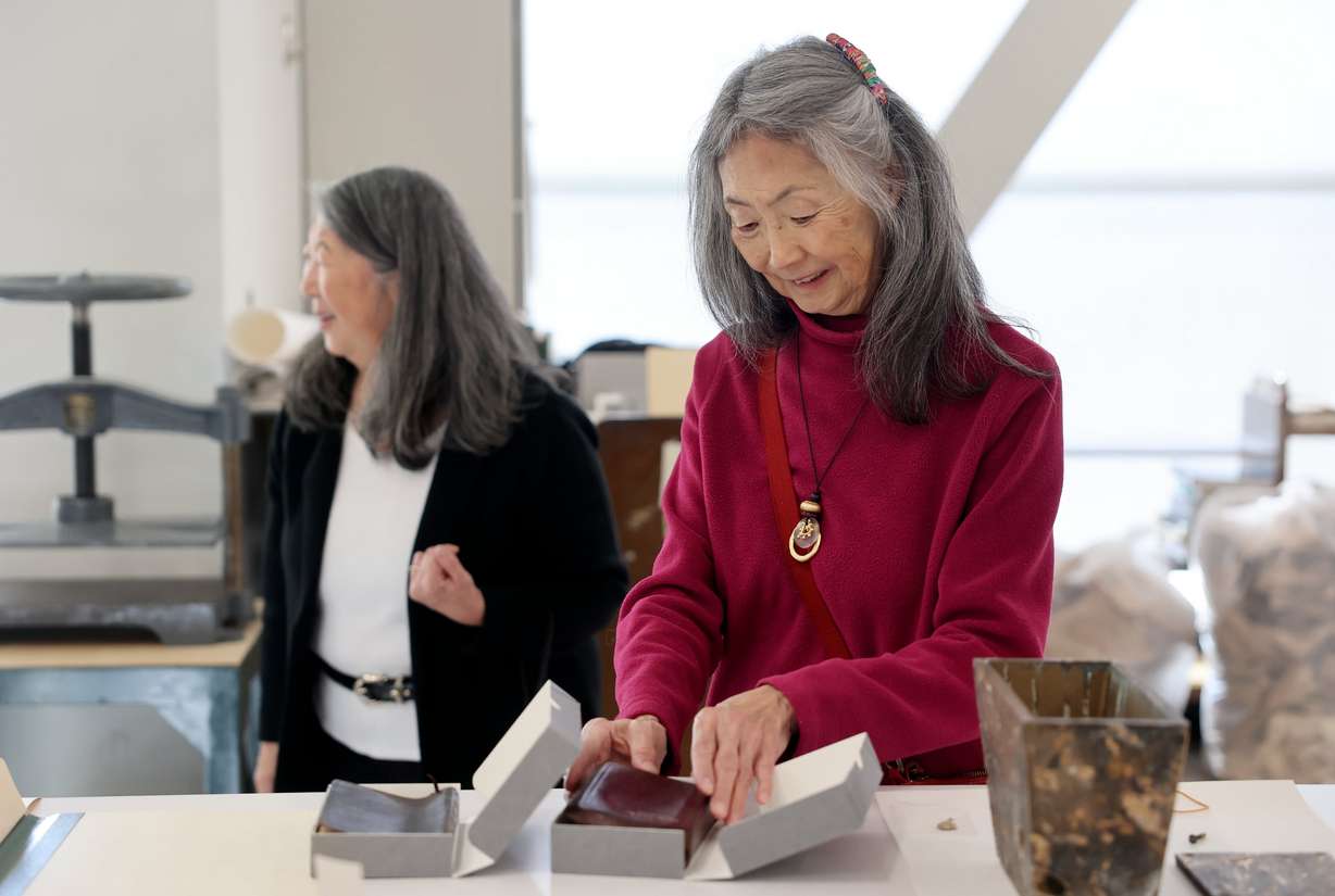 Joy Hashimoto Douglass looks at a Bible donated in 1924 by her father, Eddie Hashimoto, at the University of Utah Marriott Library Preservation Department in Salt Lake City on Oct. 20. The Bible, as well as a New Testament, donated by her mother, Lois Hide Hashimoto, were included in the contents of a Japanese Church of Christ’s 101-year-old time capsule that was recently opened
