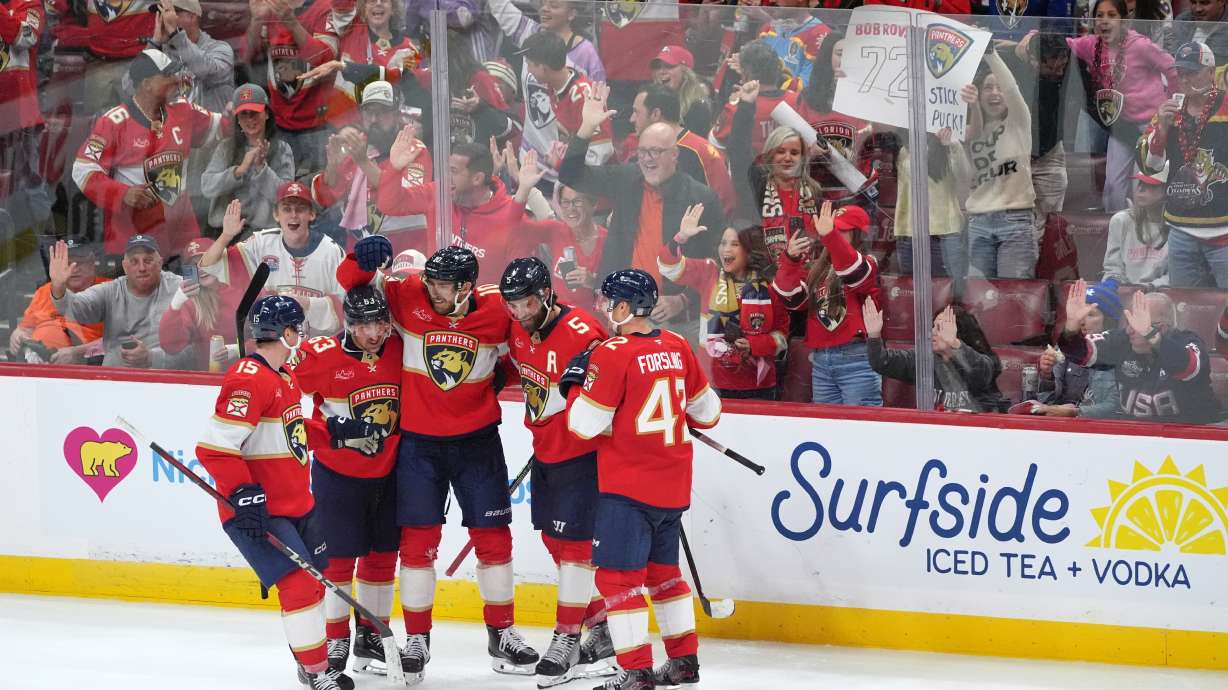 Florida Panthers left wing A.J. Greer (10) celebrates with teammates including left wing Brad Marchand (63) and defenseman Aaron Ekblad (5) after scoring the team's third goal against the Vegas Golden Knights during the third period of an NHL hockey game, Saturday, Oct. 25, 2025, in Sunrise, Fla.