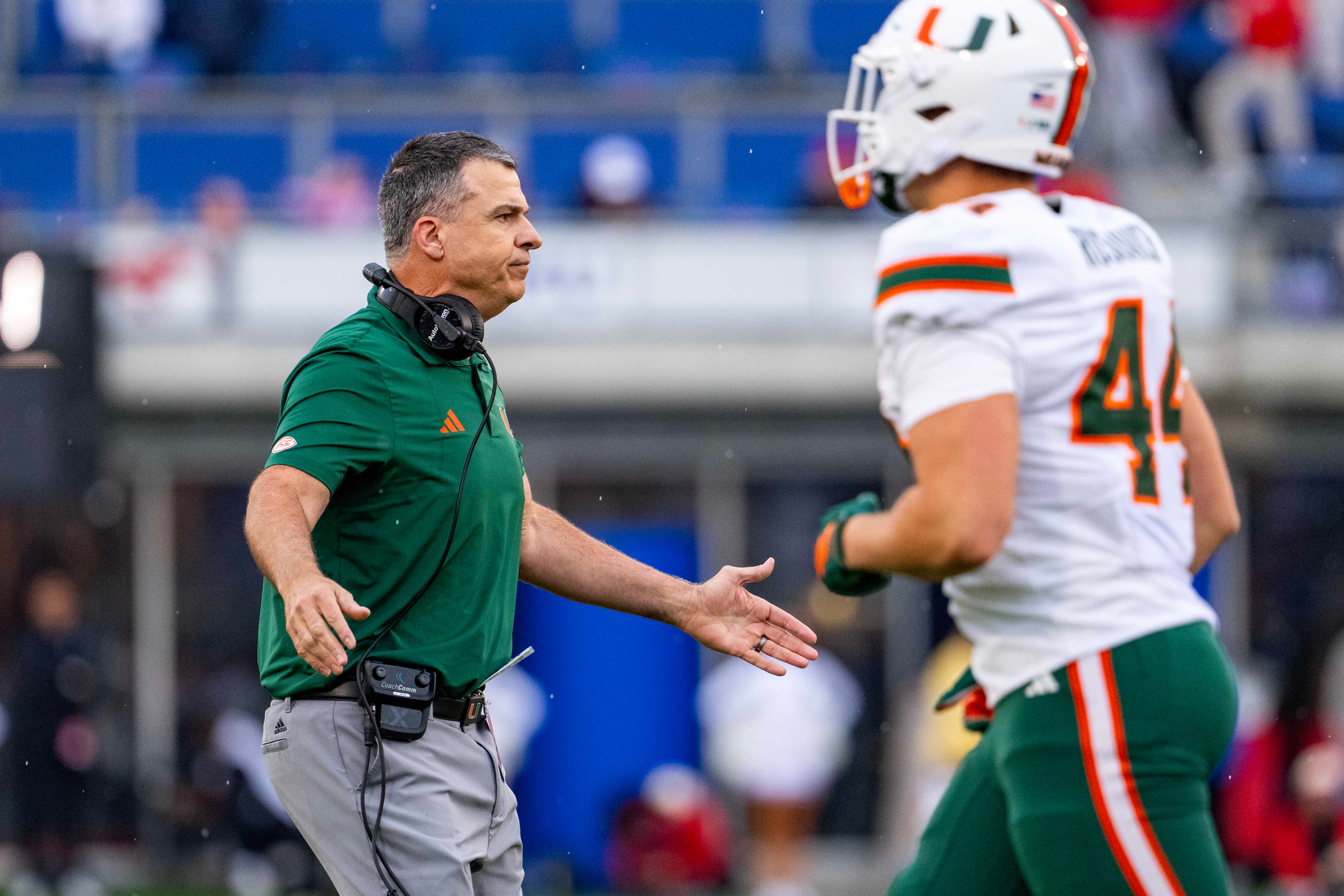 Miami head coach Mario Cristobal greets players as they come off the field during the first half of an NCAA college football game against SMU, Saturday, Nov. 1, 2025, in Dallas. 