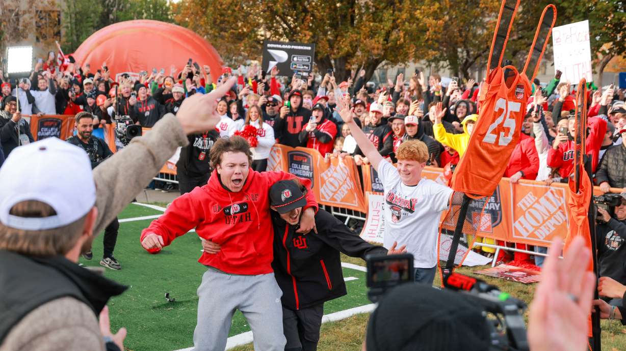 Jonah Knubel, left, celebrates after making a field goal on his second attempt for Pat McAfee’s Kicking Contest during ESPN’s “College GameDay” in the President's Circle at the University of Utah in Salt Lake City on Saturday.