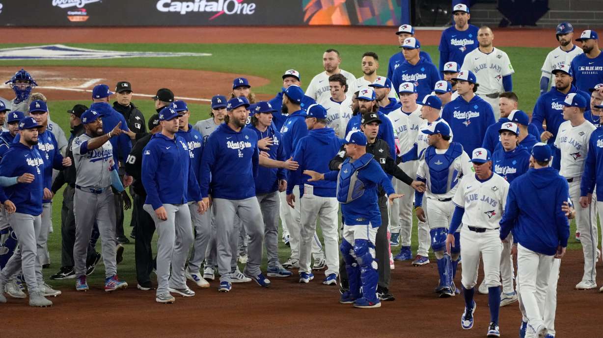 The Los Angeles Dodgers and the Toronto Blue Jays benches clear after Blue Jays' Andrés Giménez was hit by a pitch during the fourth inning in Game 7 of baseball's World Series, Saturday, Nov. 1, 2025, in Toronto.