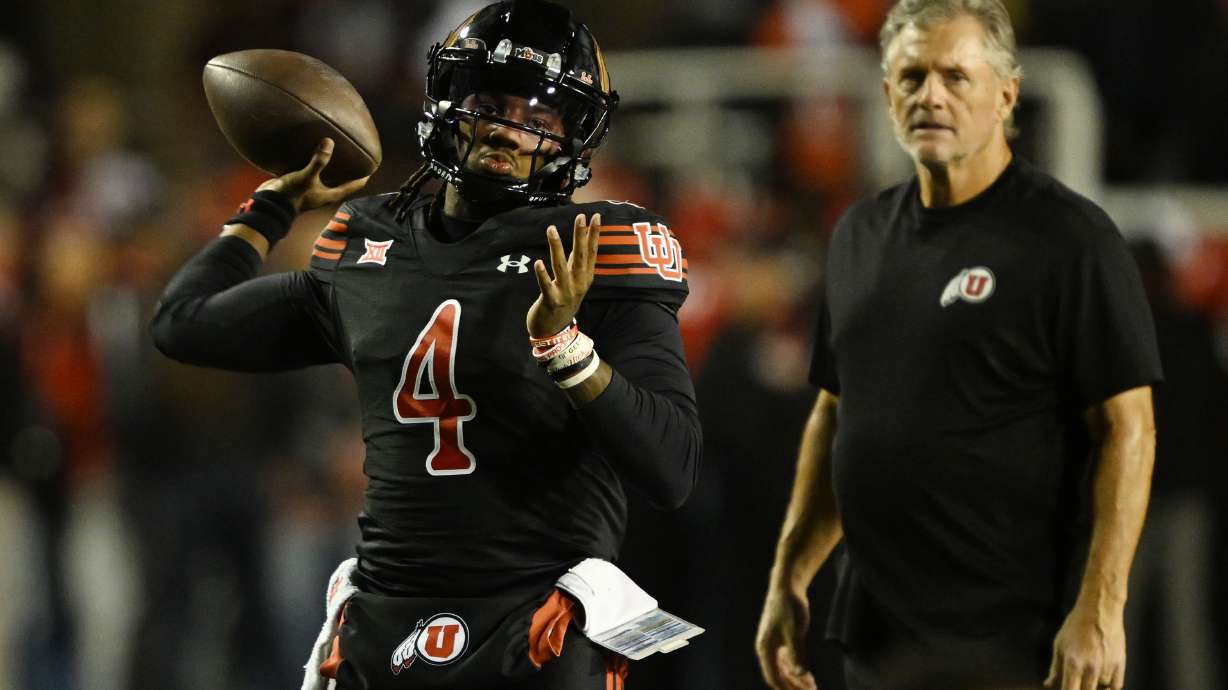 Utah Utes head coach Kyle Whittingham watches as Utah Utes quarterback Devon Dampier (4) warms up prior to Utah and Cincinnati playing at Rice-Eccles Stadium in Salt Lake City on Saturday, Nov. 1, 2025.
