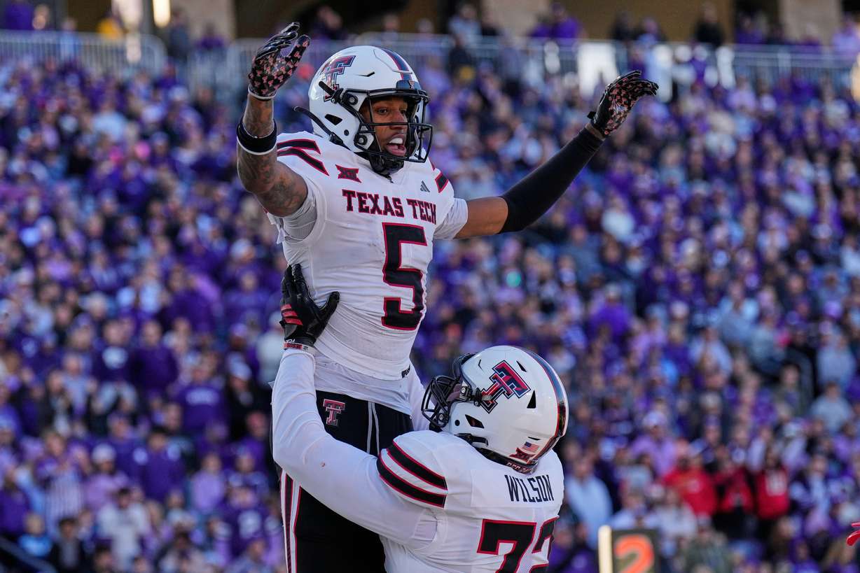 Texas Tech wide receiver Caleb Douglas (5) celebrates with offensive lineman Sheridan Wilson after scoring a touchdown during the second half of an NCAA college football game against Kansas State, Saturday, Nov. 1, 2025, in Manhattan, Kan.