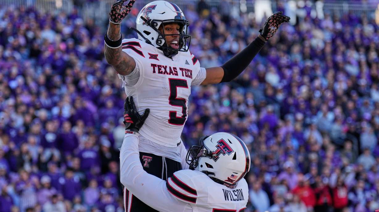Texas Tech wide receiver Caleb Douglas (5) celebrates with offensive lineman Sheridan Wilson after scoring a touchdown during the second half of an NCAA college football game against Kansas State, Saturday, Nov. 1, 2025, in Manhattan, Kan.