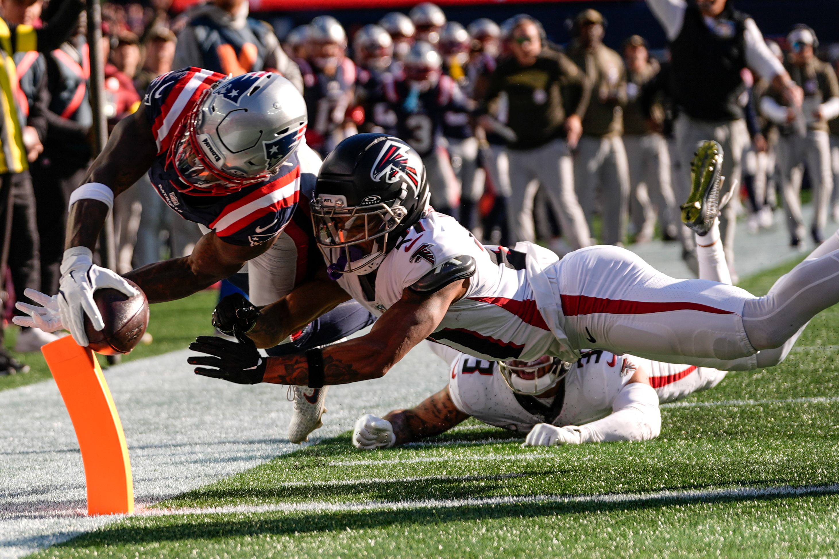 New England Patriots wide receiver Stefon Diggs (8) scores a touchdown against Atlanta Falcons cornerback Mike Hughes (21) during the first half of an NFL football game, Sunday, Nov. 2, 2025, in Foxborough, Mass. 