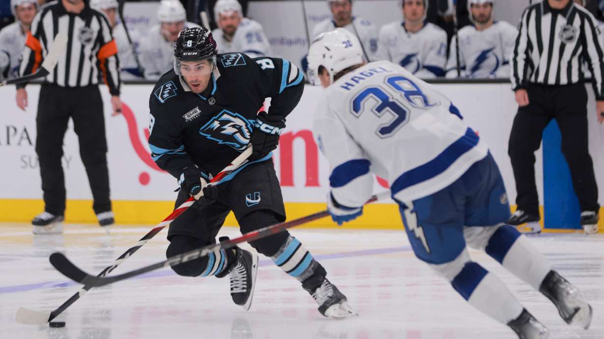 Utah Mammoth center Nick Schmaltz (8) moves the puck against Tampa Bay Lightning left wing Brandon Hagel (38) during the third period of an NHL game at the Delta Center in Salt Lake City on Sunday, Nov. 2, 2025.