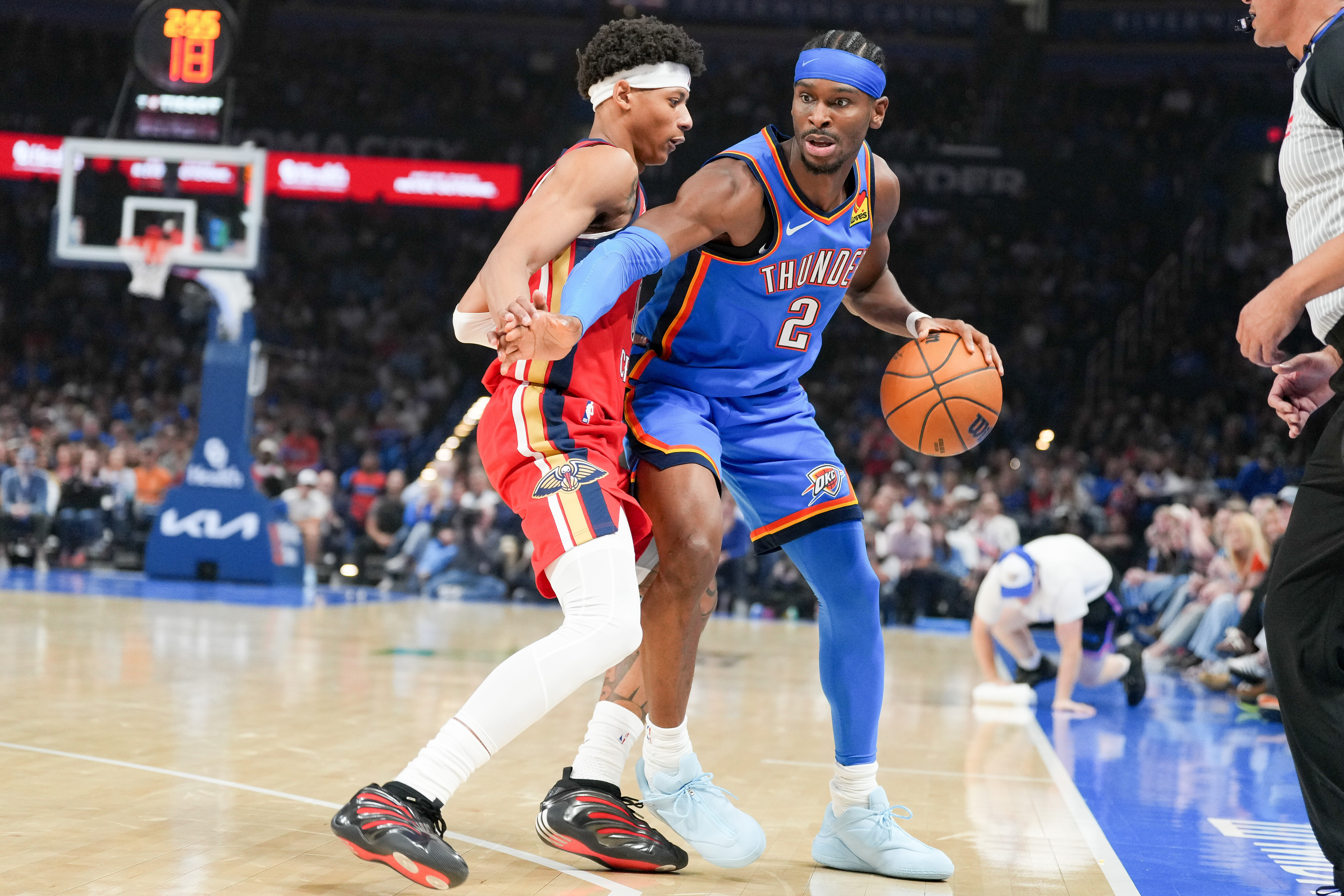 Oklahoma City Thunder guard Shai Gilgeous-Alexander (2) pushes past New Orleans Pelicans guard Jeremiah Fears, left, during the first half of an NBA basketball game, Sunday, Nov. 2, 2025, in Oklahoma City.