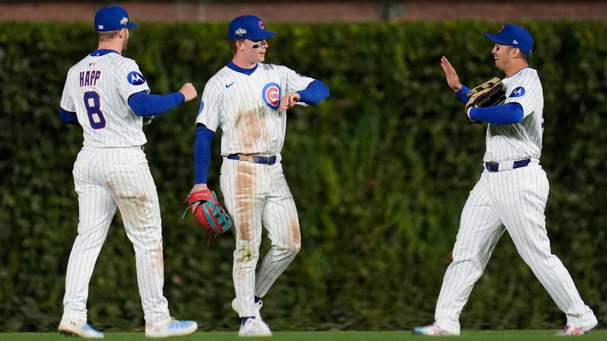Chicago Cubs' Ian Happ, Pete Crow-Armstrong and Seiya Suzuki celebrate after Game 3 of baseball's National League Division Series against the Milwaukee Brewers Wednesday, Oct. 8, 2025, in Chicago.