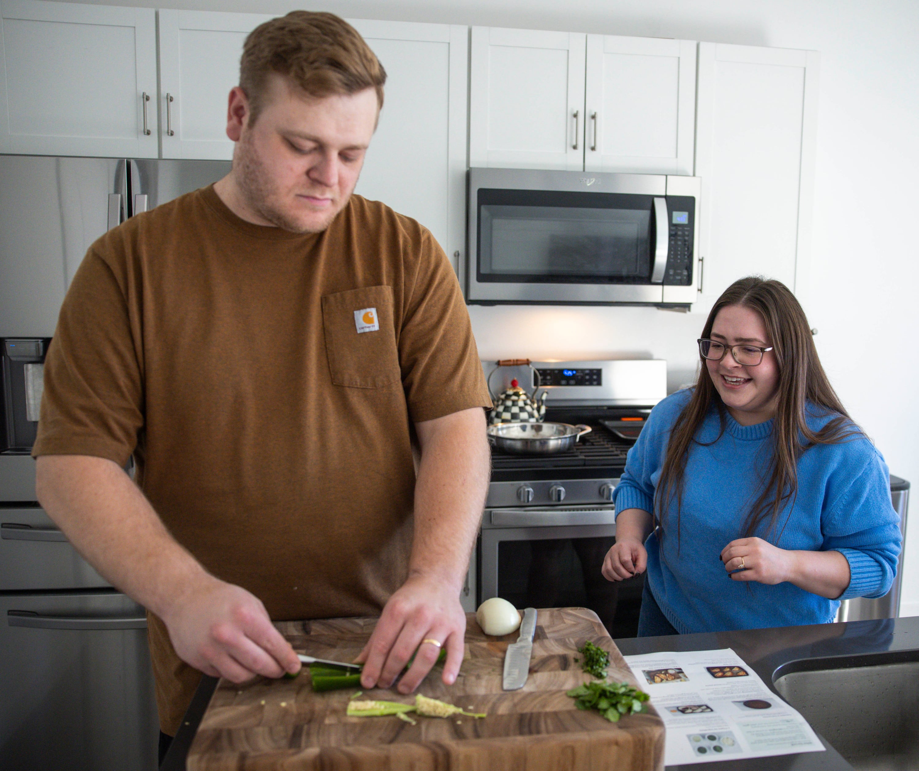 Bryan Edwards, left, and his wife, Emma Mendez-Edwards, make dinner at their home in Heber City on Saturday.
