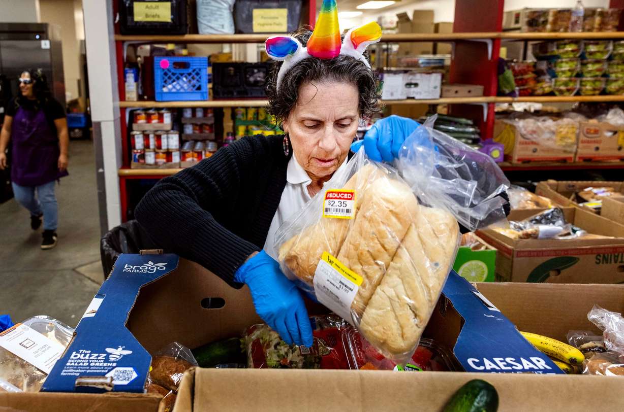 Volunteer Christina Gringeri organizes boxes of food before the doors open at Hildegarde's Food Pantry in Salt Lake City on Friday. The pantry is a ministry of the Cathedral Church of St. Mark.